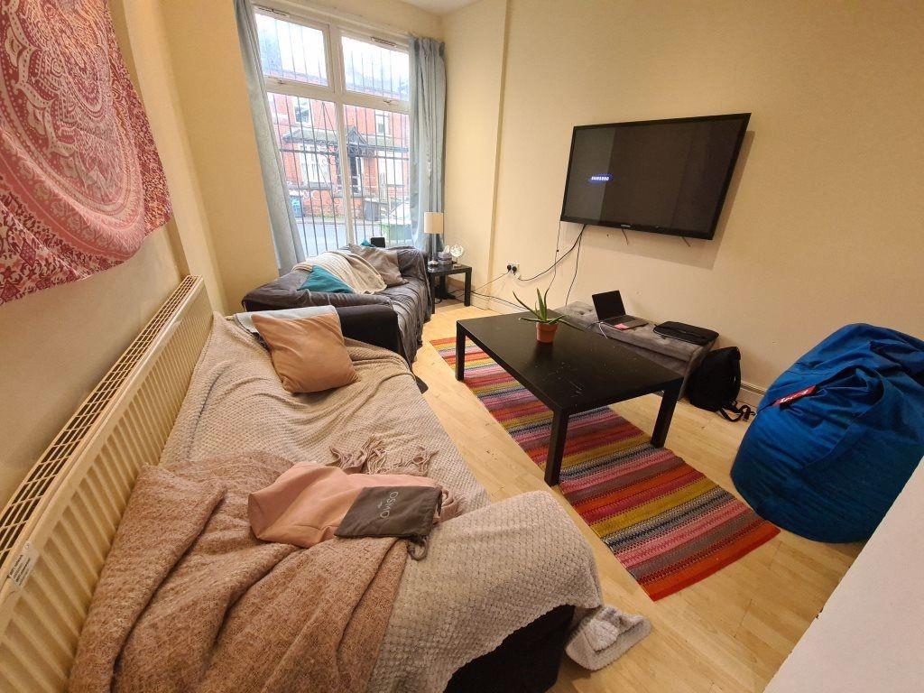 A cozy single bedroom featuring a bed, a wall-m...