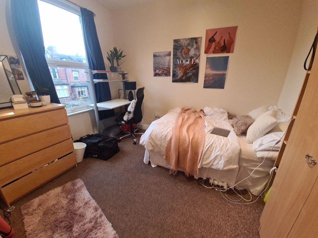 A cozy bedroom featuring a comfortable bed with...
