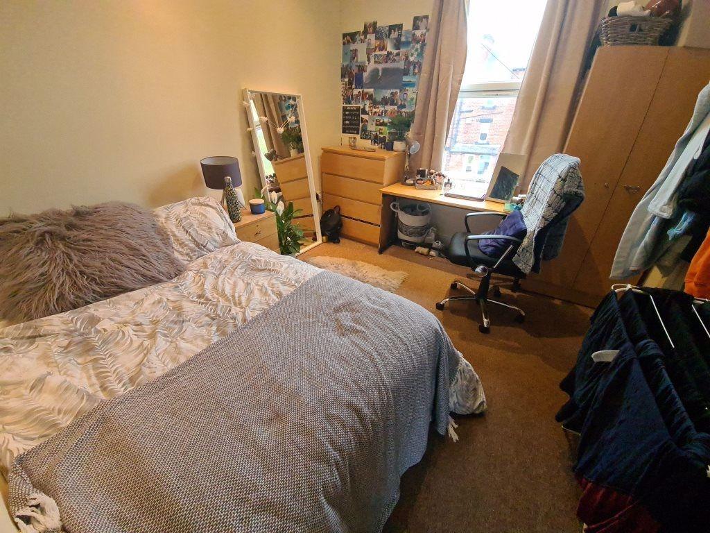 A cozy and well-maintained bedroom with a doubl...