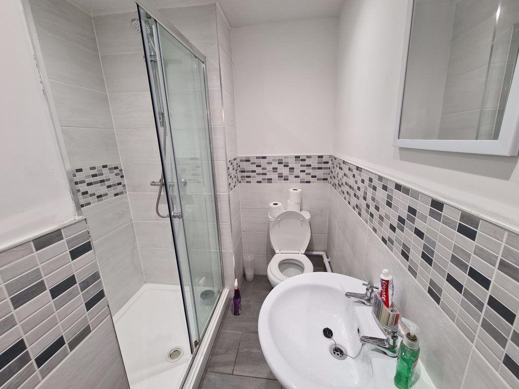 Modern bathroom featuring a large shower, clean...