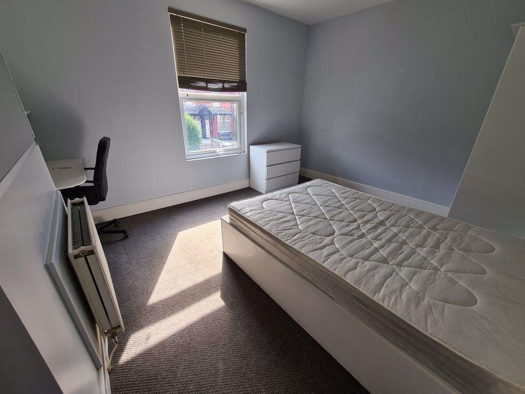 A bright and clean double bedroom featuring a c...