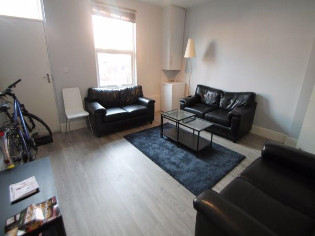 A spacious and well-lit living room featuring t...