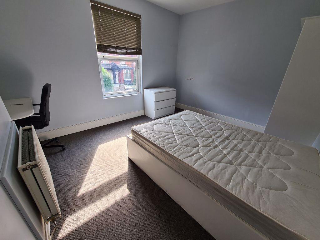 A bright and tidy double bedroom featuring a co...