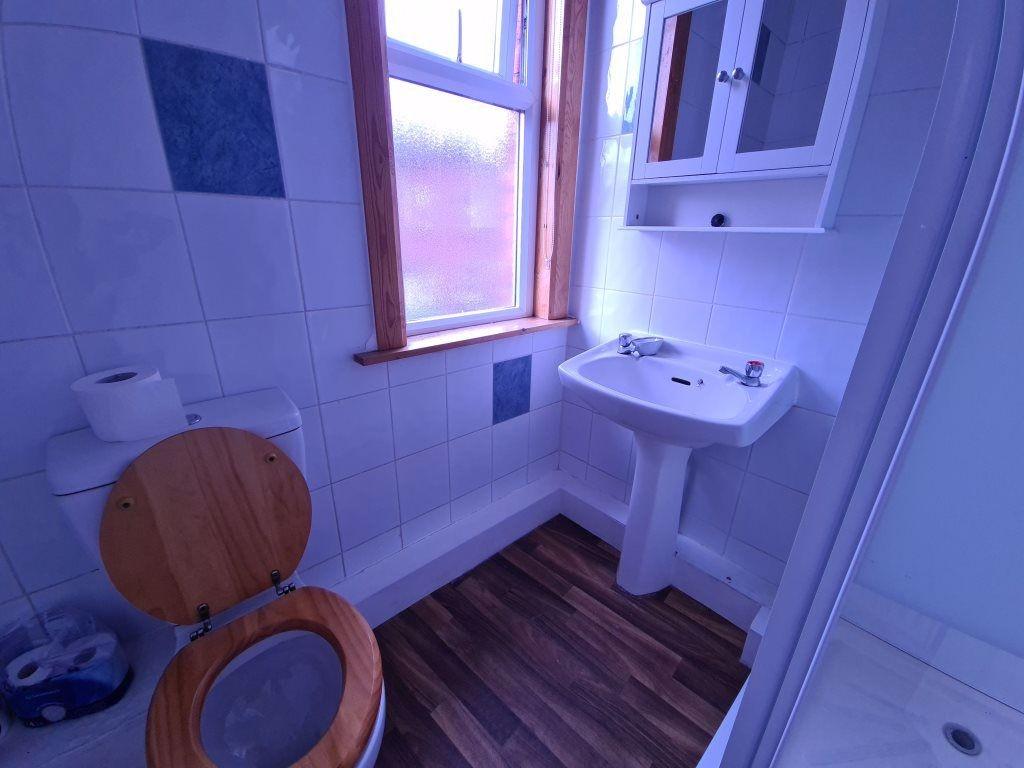 A bright and clean bathroom featuring a classic...