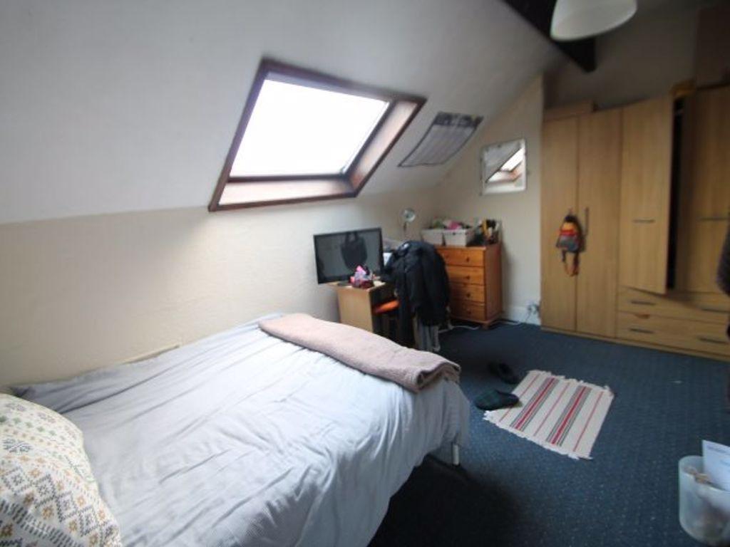 A cozy bedroom illuminated by natural light fro...