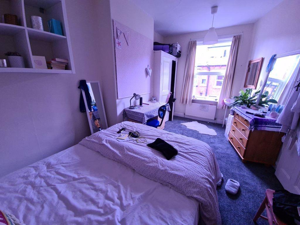 A bright and tidy bedroom featuring a double be...