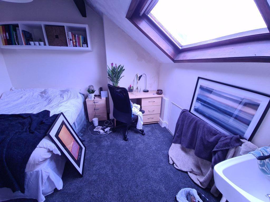 A bright and well-maintained bedroom with ample...