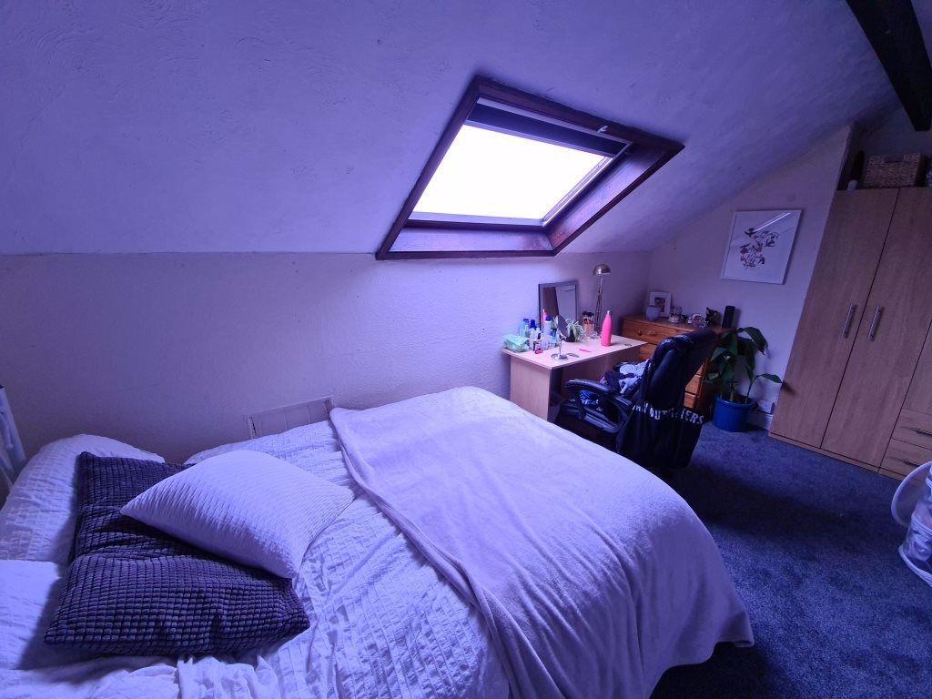 A cozy and well-maintained bedroom featuring a ...
