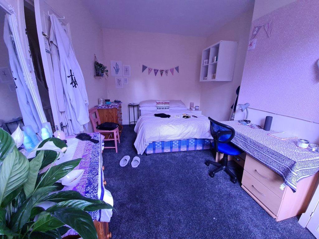 A spacious and well-lit master bedroom featurin...