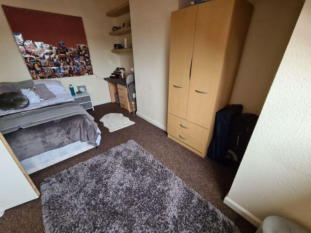 A well-kept bedroom featuring a double bed, war...