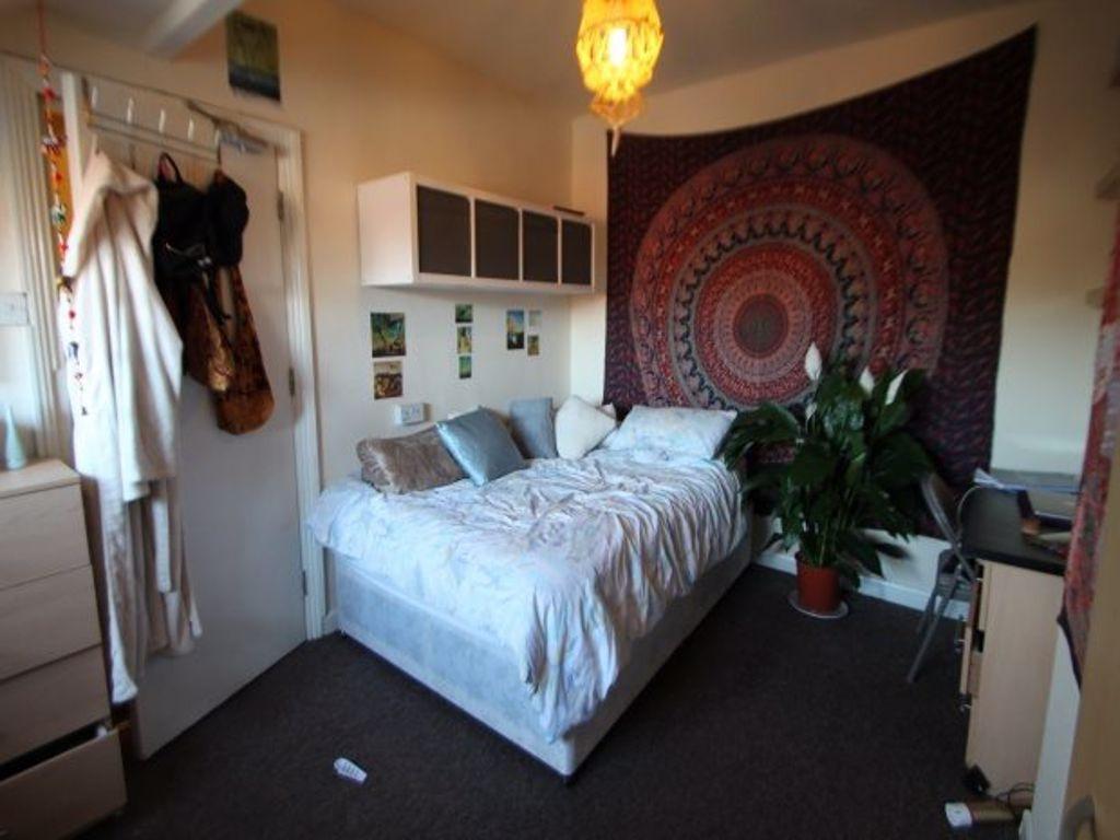 A spacious and well-lit master bedroom featurin...