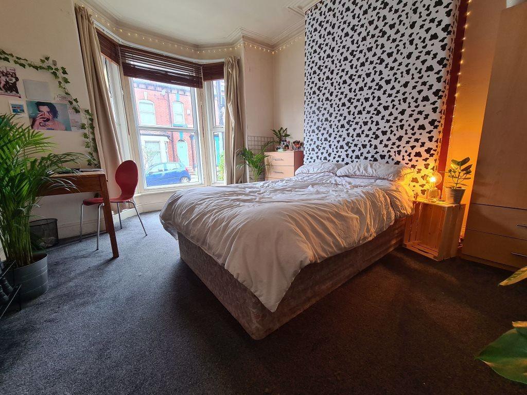 A bright and well-maintained bedroom with a com...