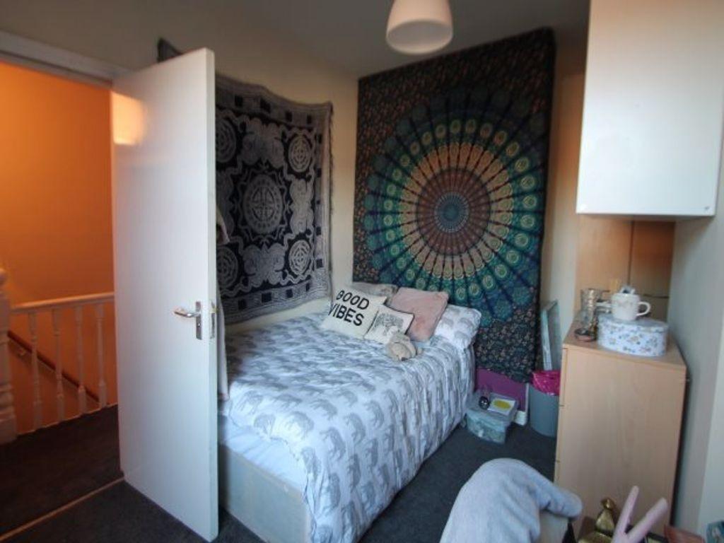 A cozy and well-maintained bedroom featuring a ...