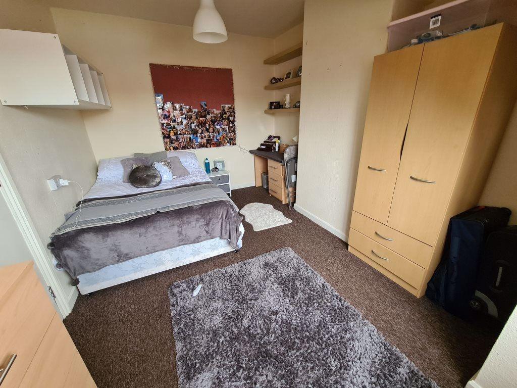 A cozy and well-maintained bedroom featuring a ...
