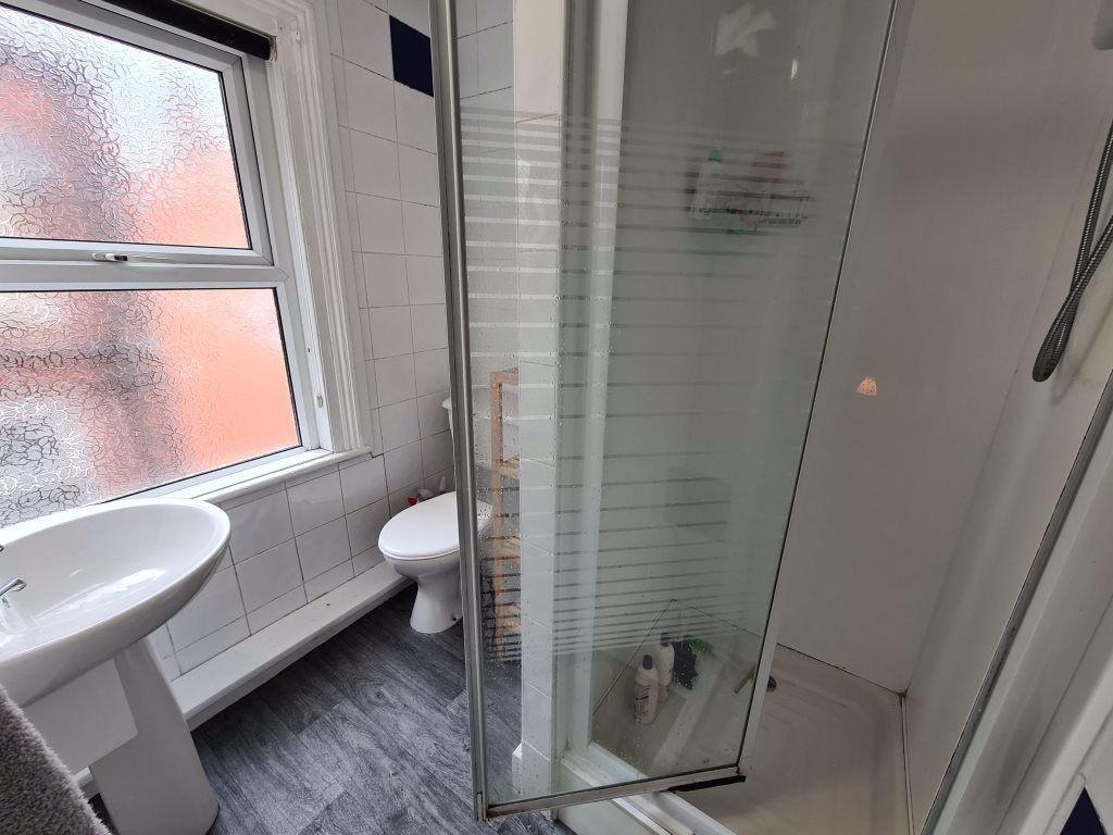 Bright and clean bathroom featuring a shower en...