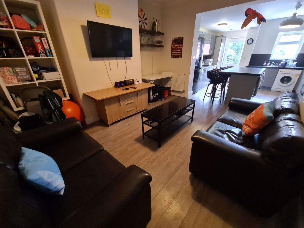 A spacious and well-lit living room featuring c...
