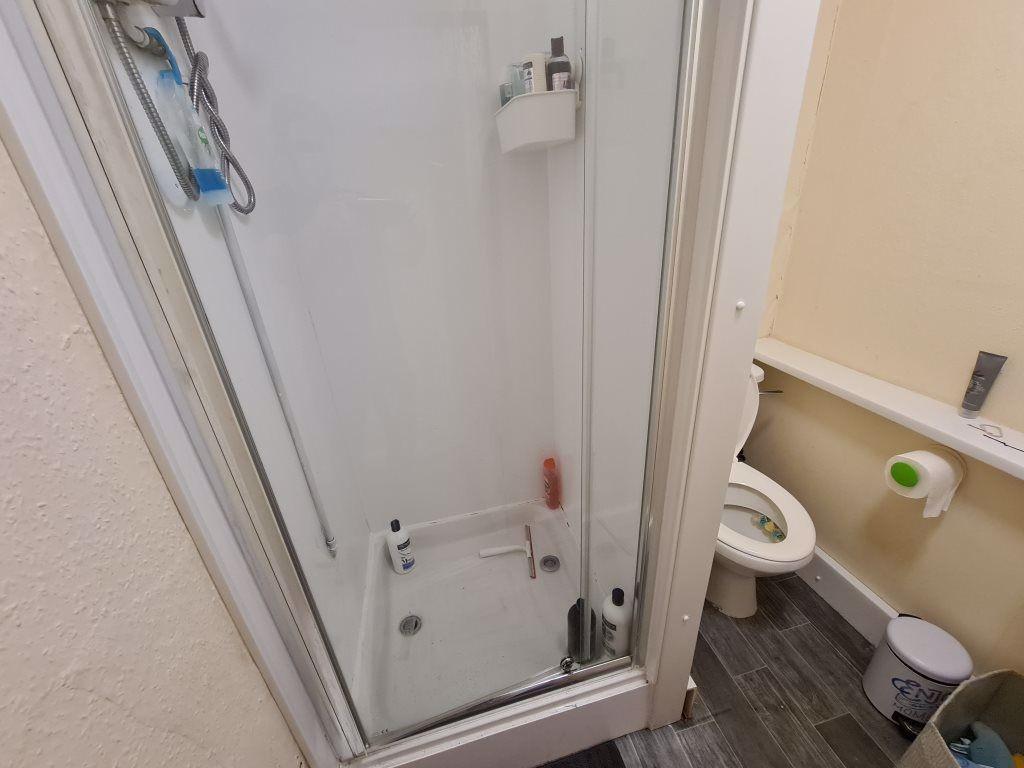 A clean and well-maintained bathroom with a sho...