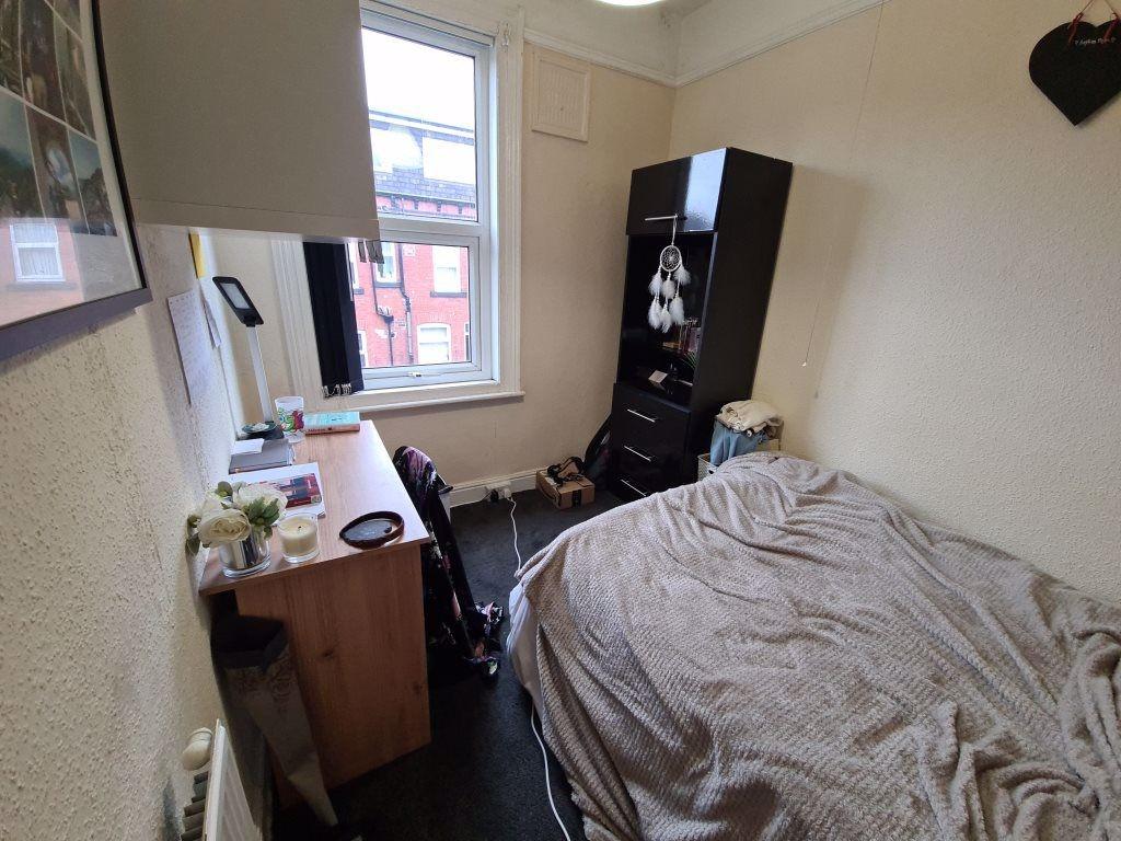 A cozy bedroom with a comfortable bed, a study ...