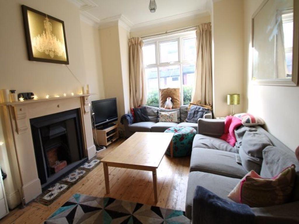 A bright and welcoming living room featuring co...