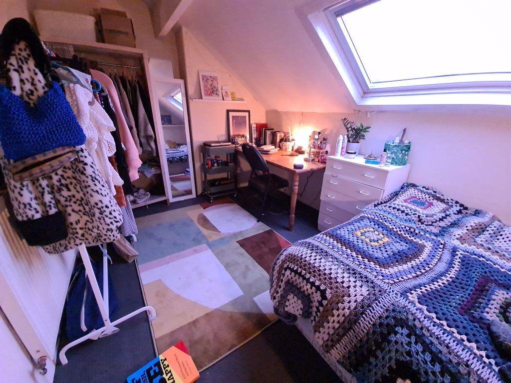 Bright and cozy bedroom featuring a comfortable...