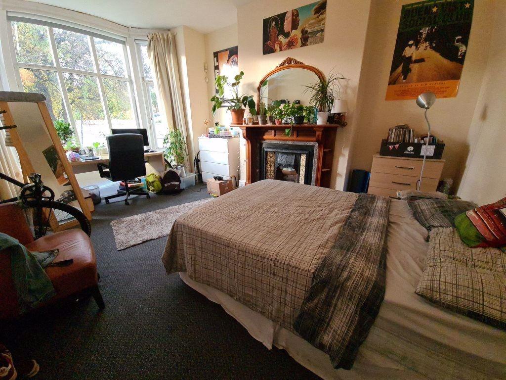A spacious and well-lit master bedroom featurin...