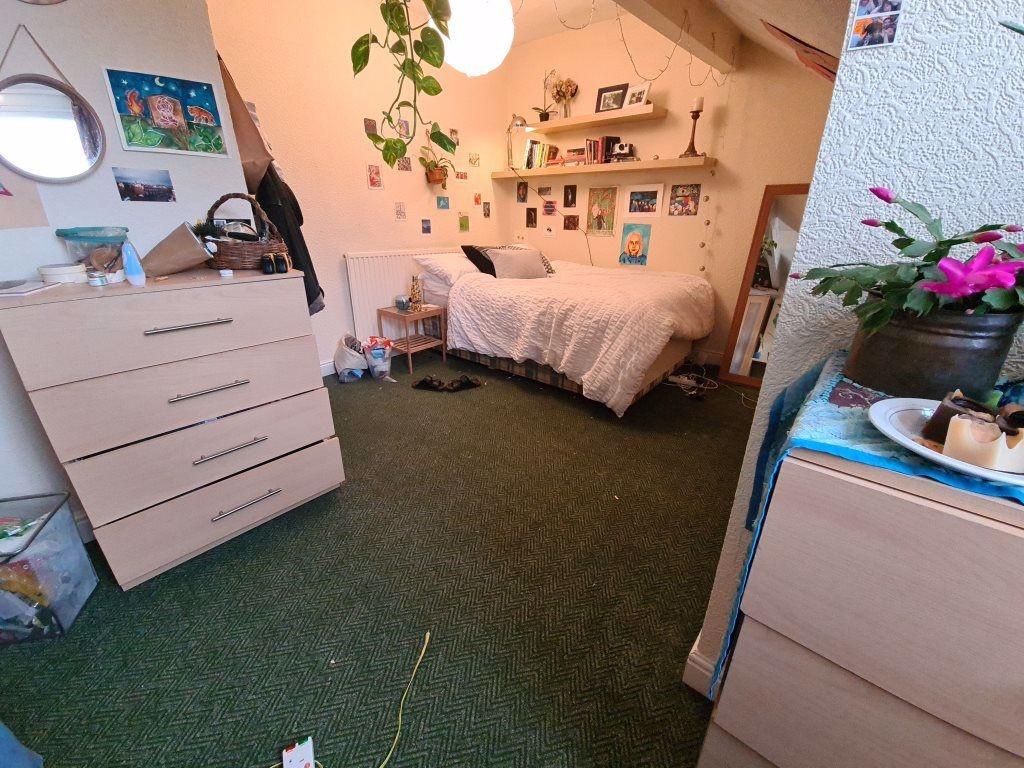 A cozy bedroom with a comfortable double bed an...