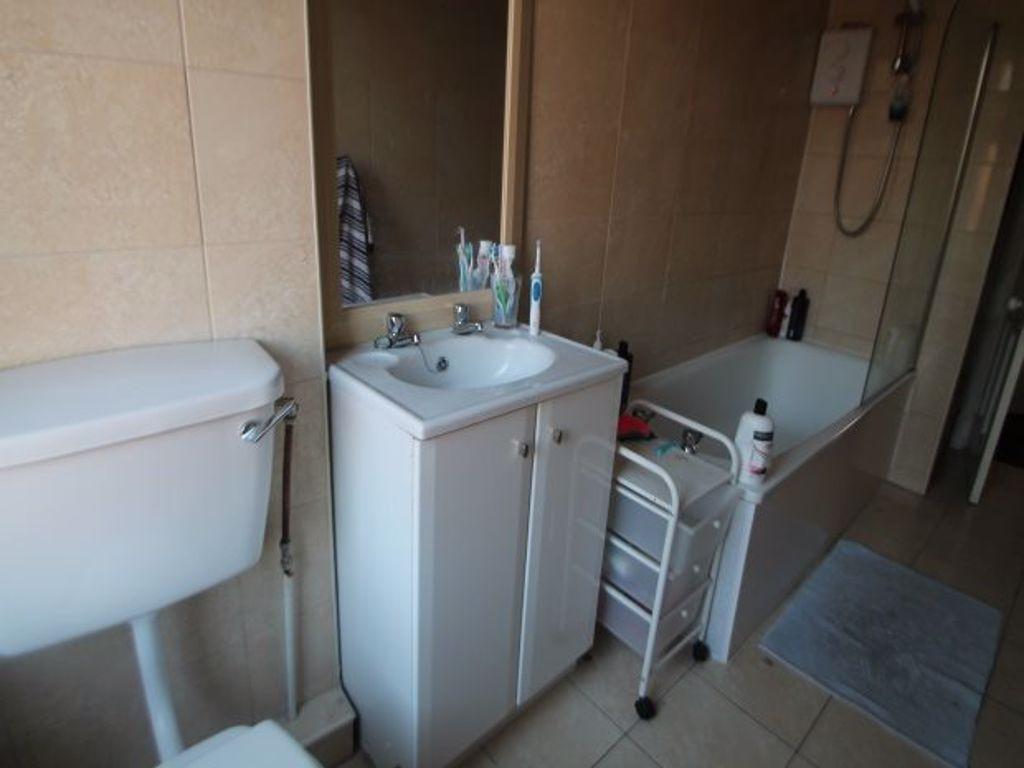 A well-maintained bathroom featuring a toilet, ...