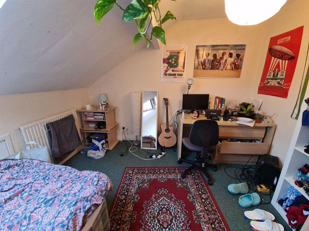 A cozy, well-lit living room featuring a comfor...