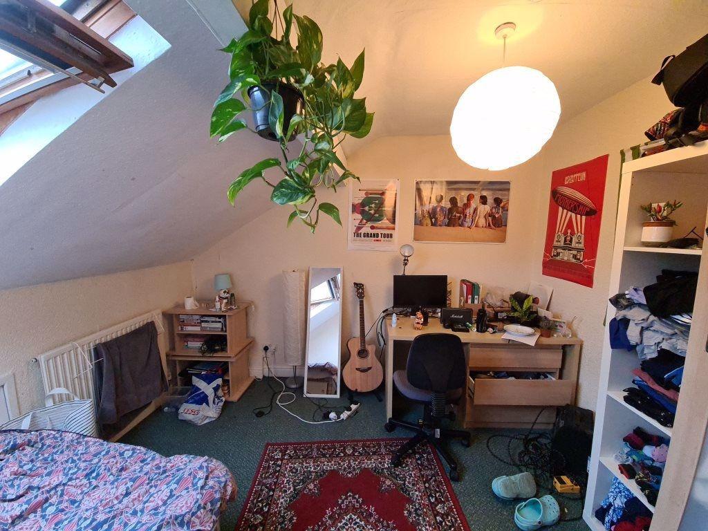 A cozy bedroom with natural light streaming in,...