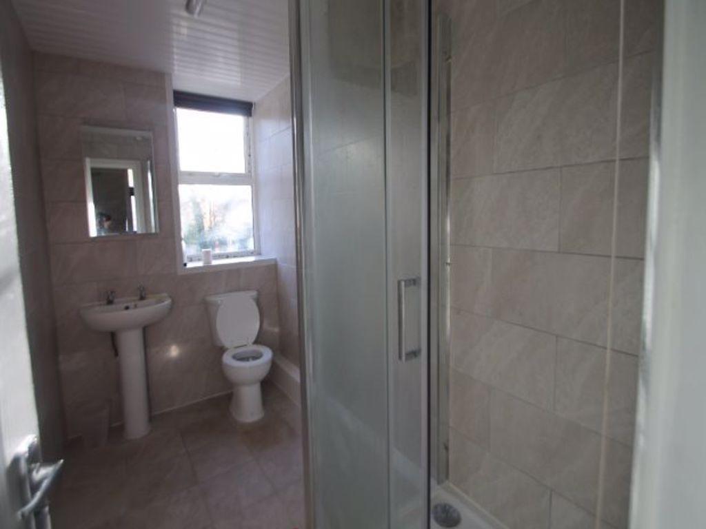 A clean and bright bathroom with a sink, toilet...