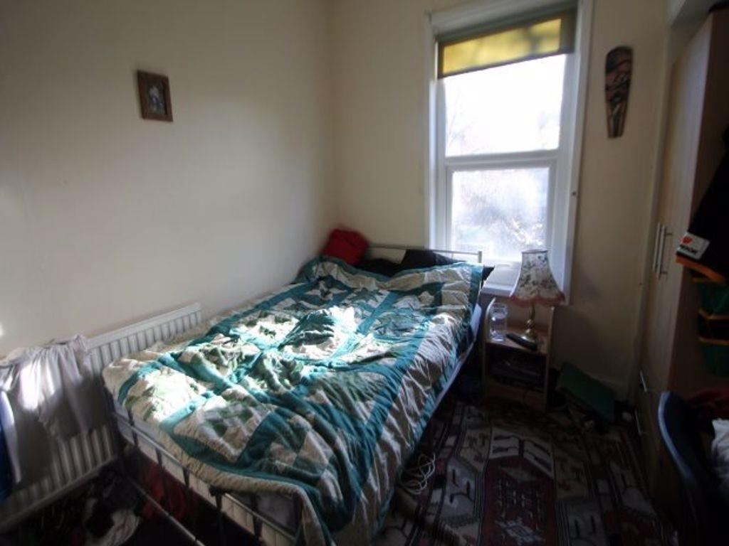 A cozy single bedroom with natural light stream...