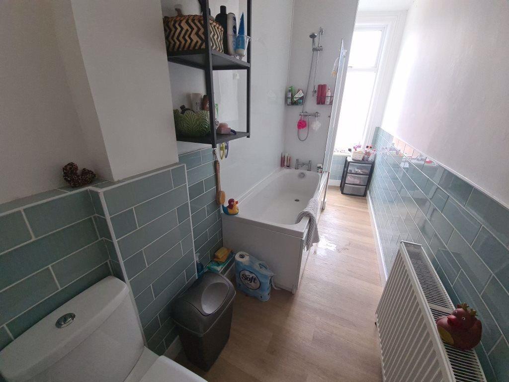 A clean and well-maintained bathroom with a bat...