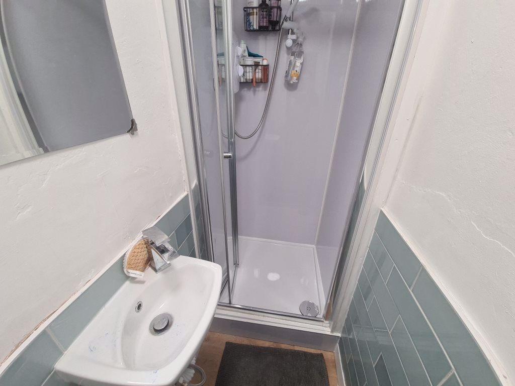 A clean and modern bathroom featuring a glass s...