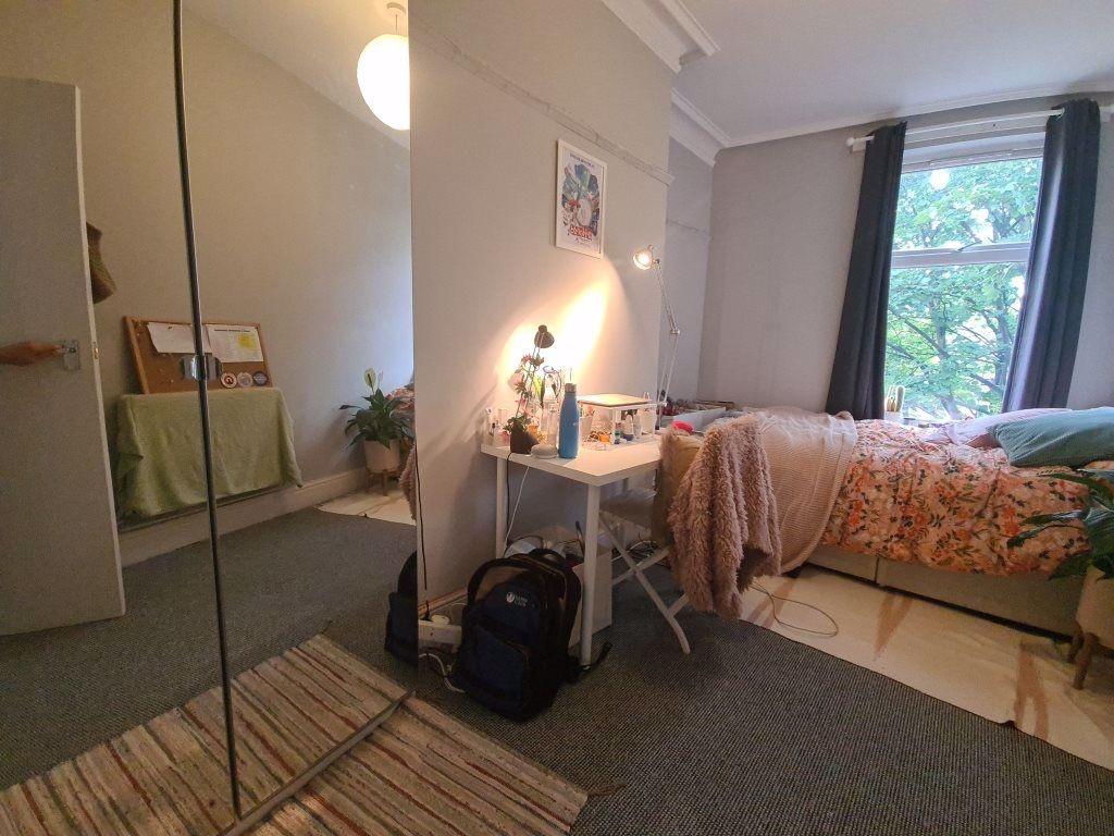 Cozy single bedroom featuring a comfortable bed...