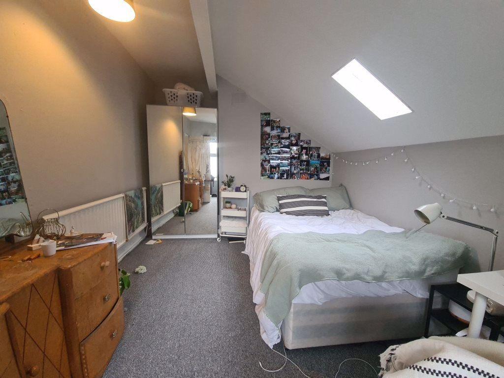 A bright and well-maintained bedroom featuring ...