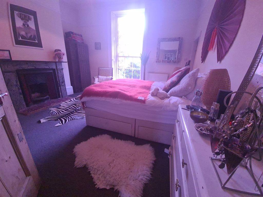 A cozy master bedroom featuring a comfortable d...