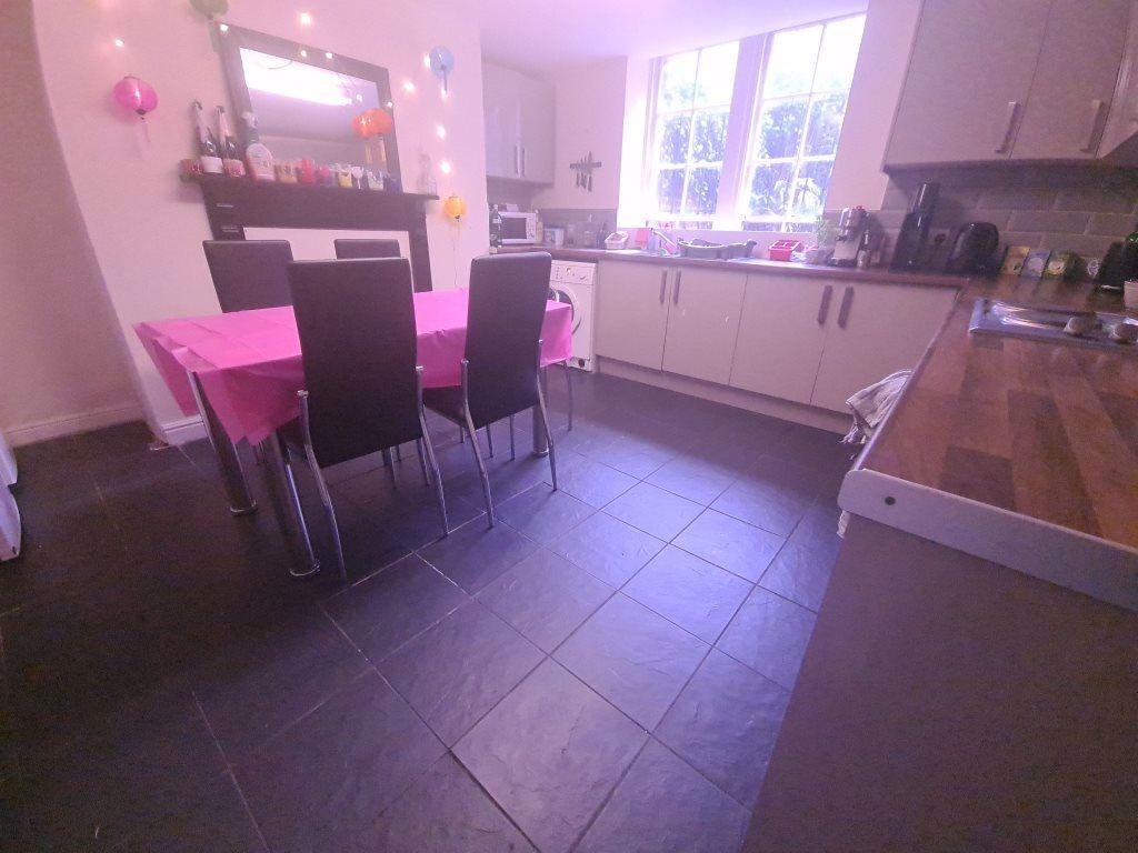 A bright, modern kitchen featuring ample counte...