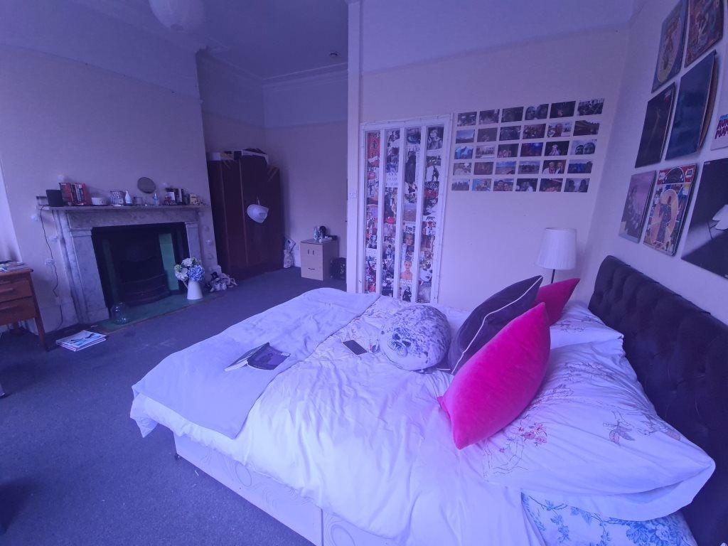 A cozy bedroom featuring a comfortable bed with...