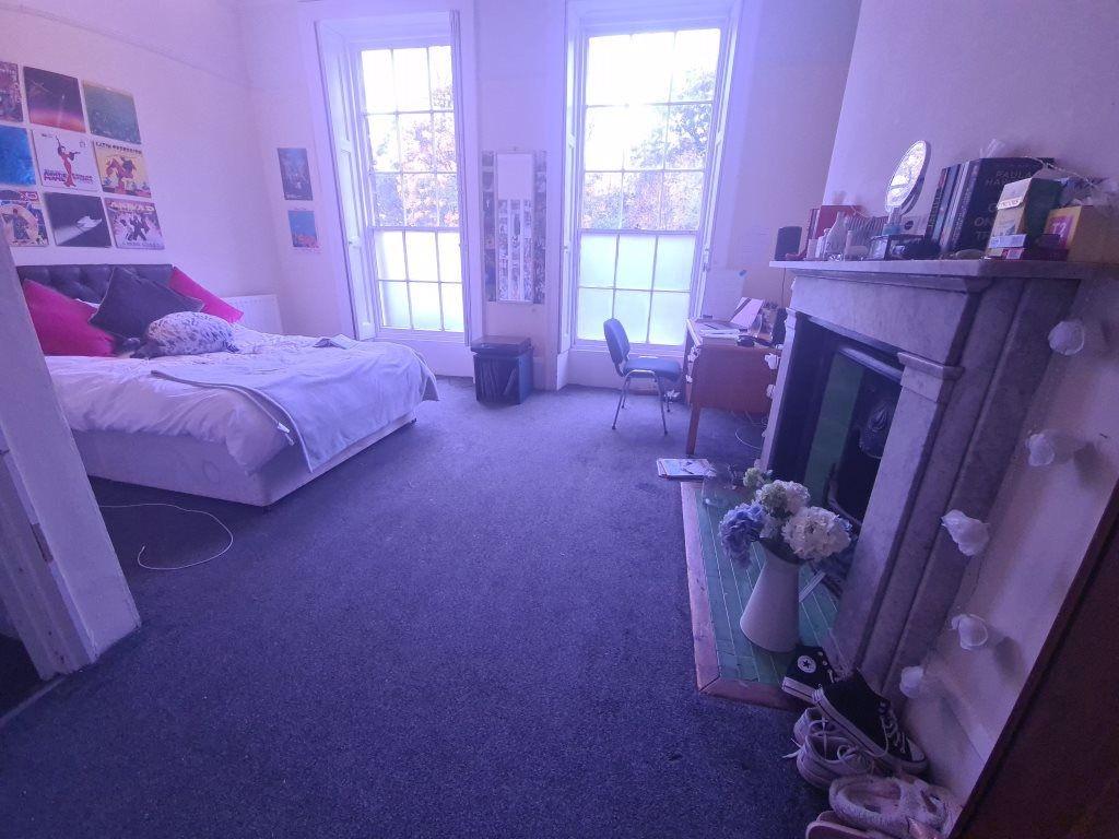 A spacious and well-lit living room featuring c...