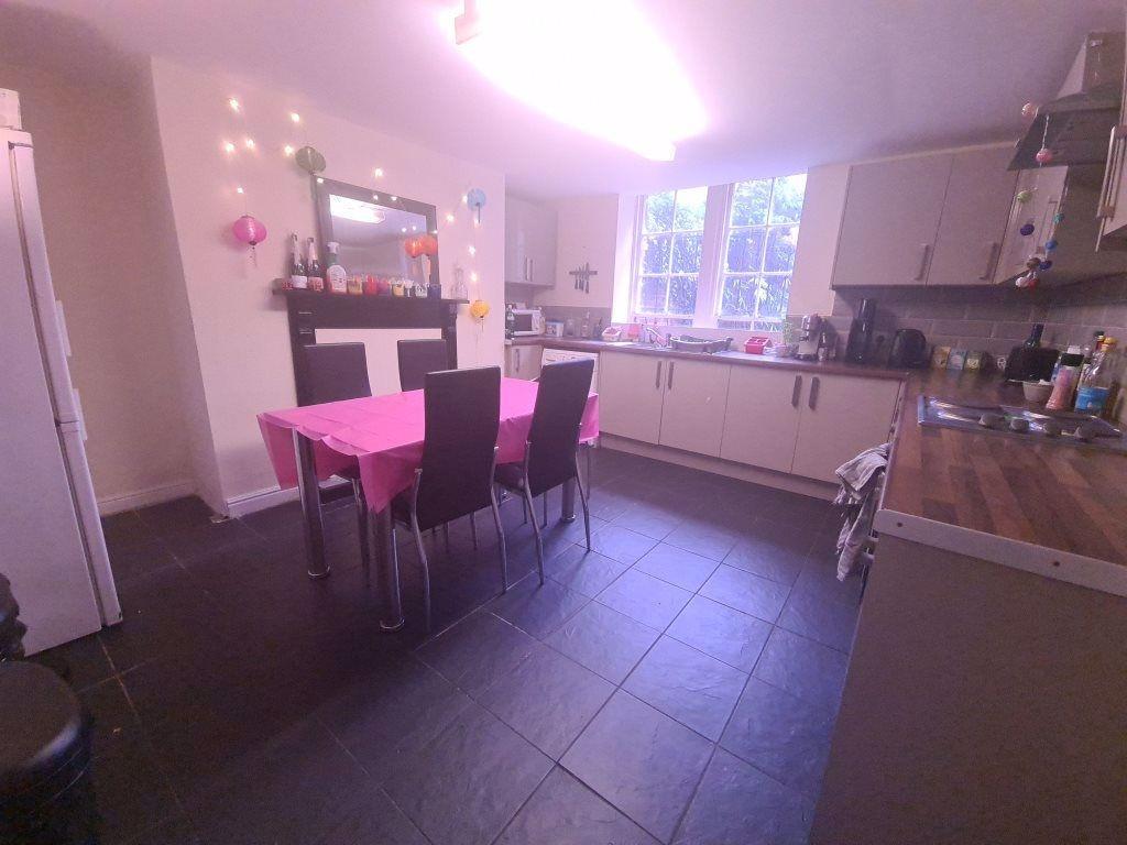 Bright and modern kitchen area with ample natur...