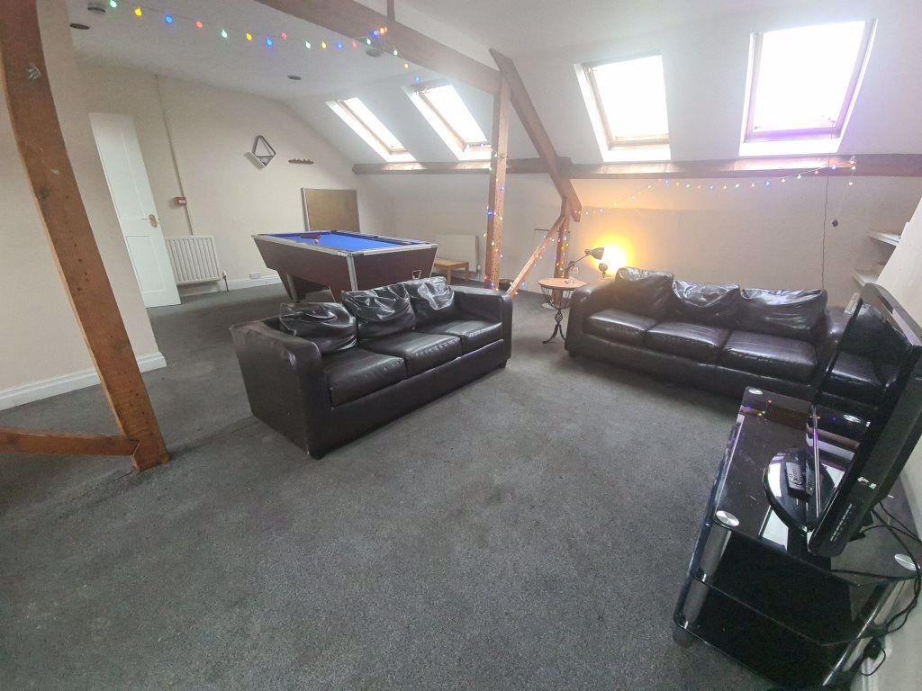 A bright and inviting living room with ample na...