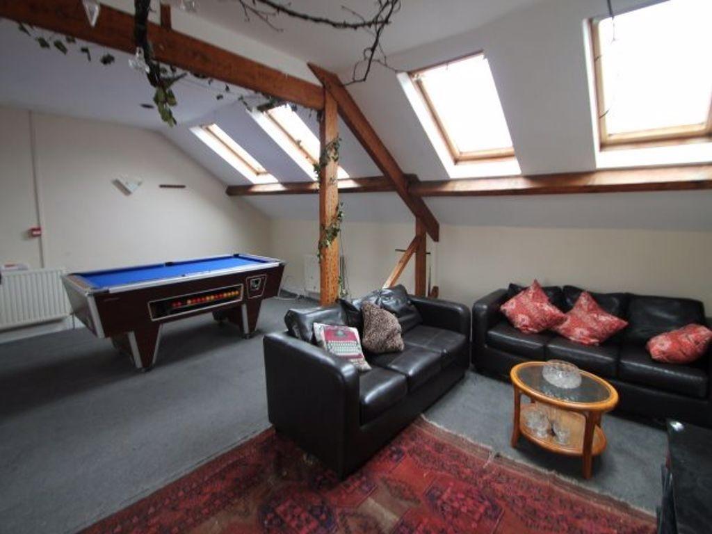 A spacious and well-lit living room featuring c...