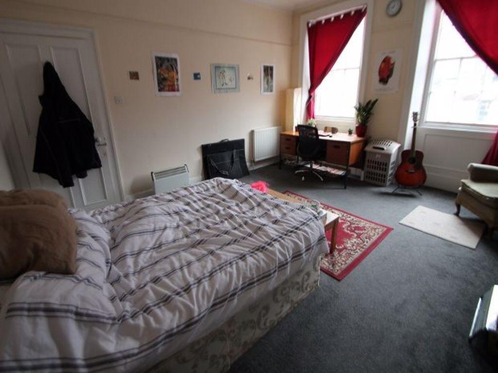 A cozy bedroom featuring a double bed with a co...