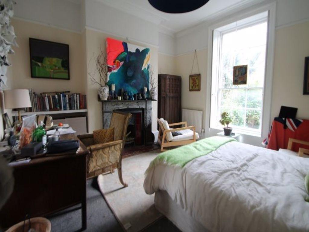 A bright, cozy bedroom with a comfortable bed, ...