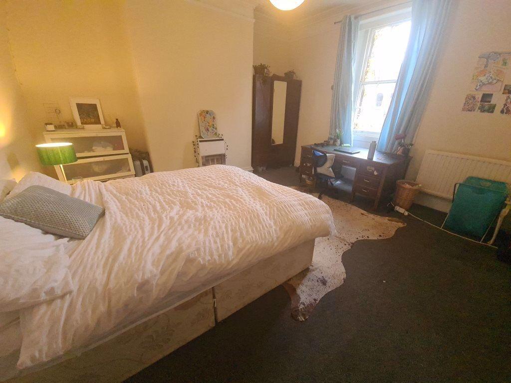 A spacious and inviting master bedroom featurin...