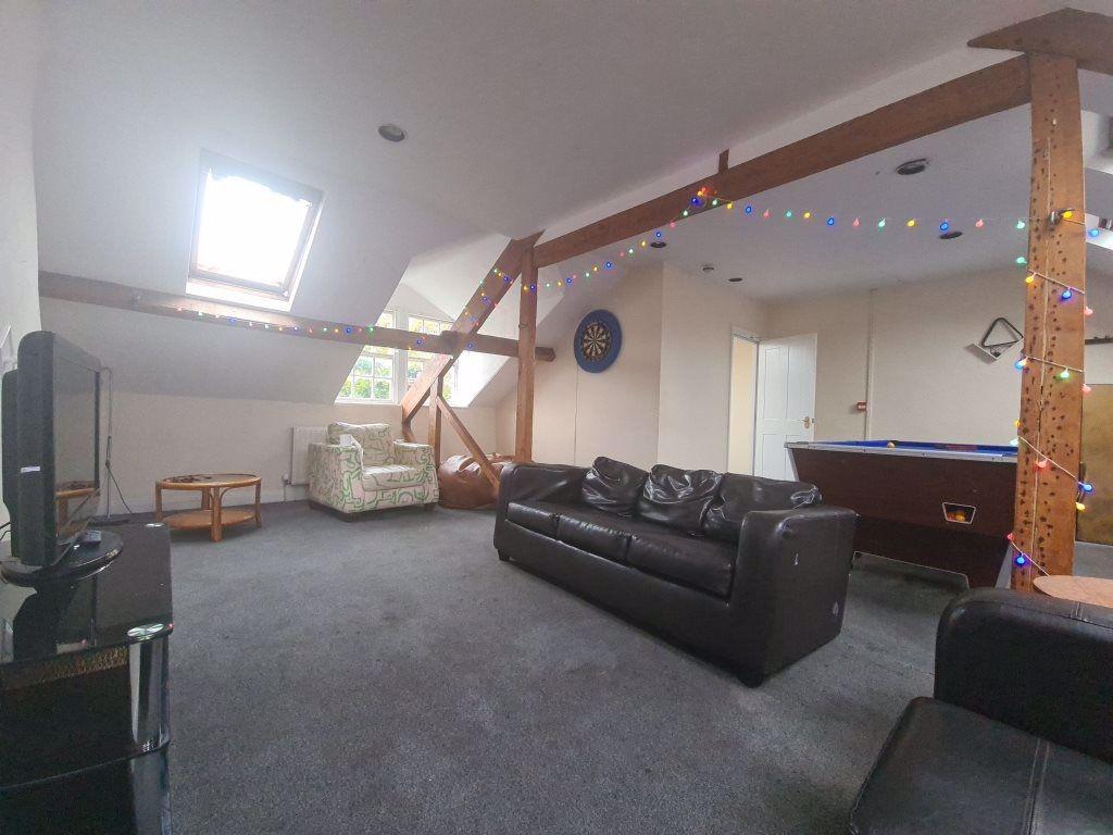 A spacious and welcoming living room with large...