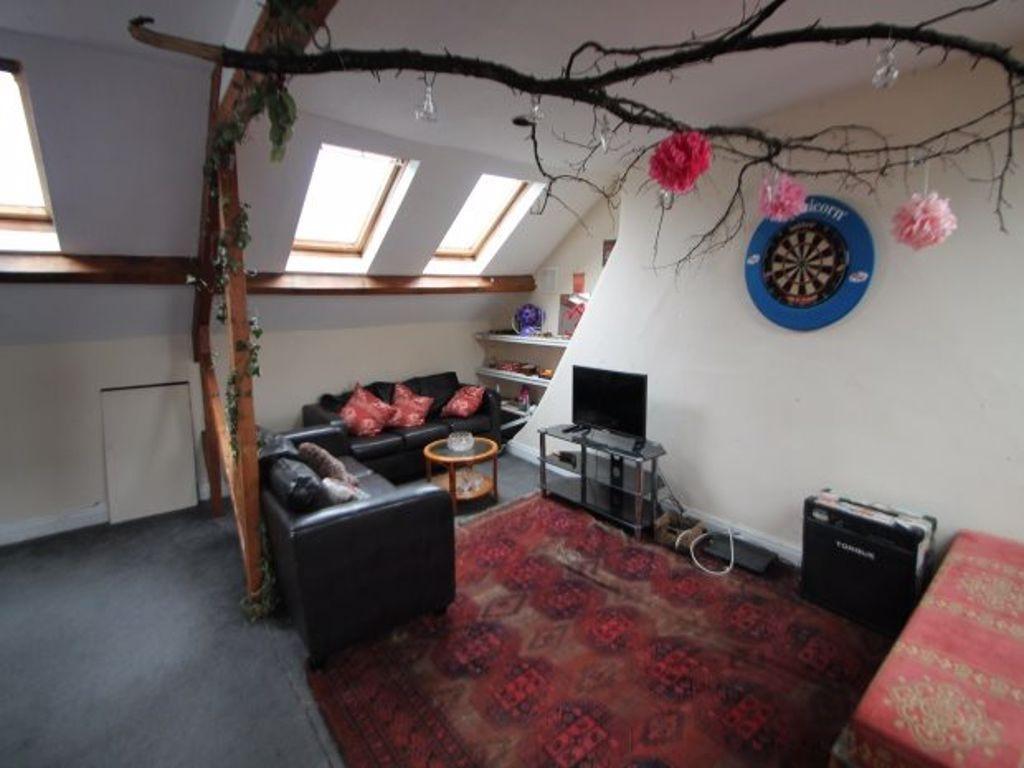 A cozy and well-lit living room featuring comfo...