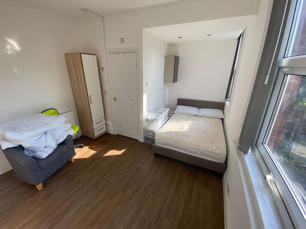 A bright and welcoming bedroom featuring a larg...