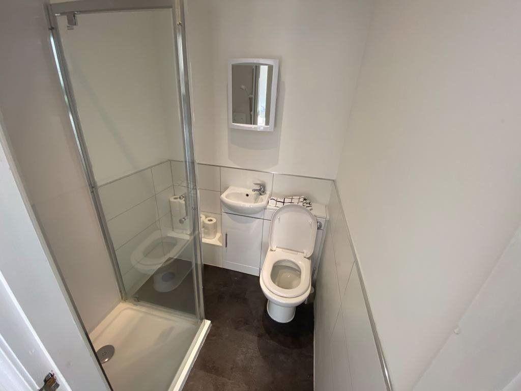 A clean and functional bathroom with a large ba...