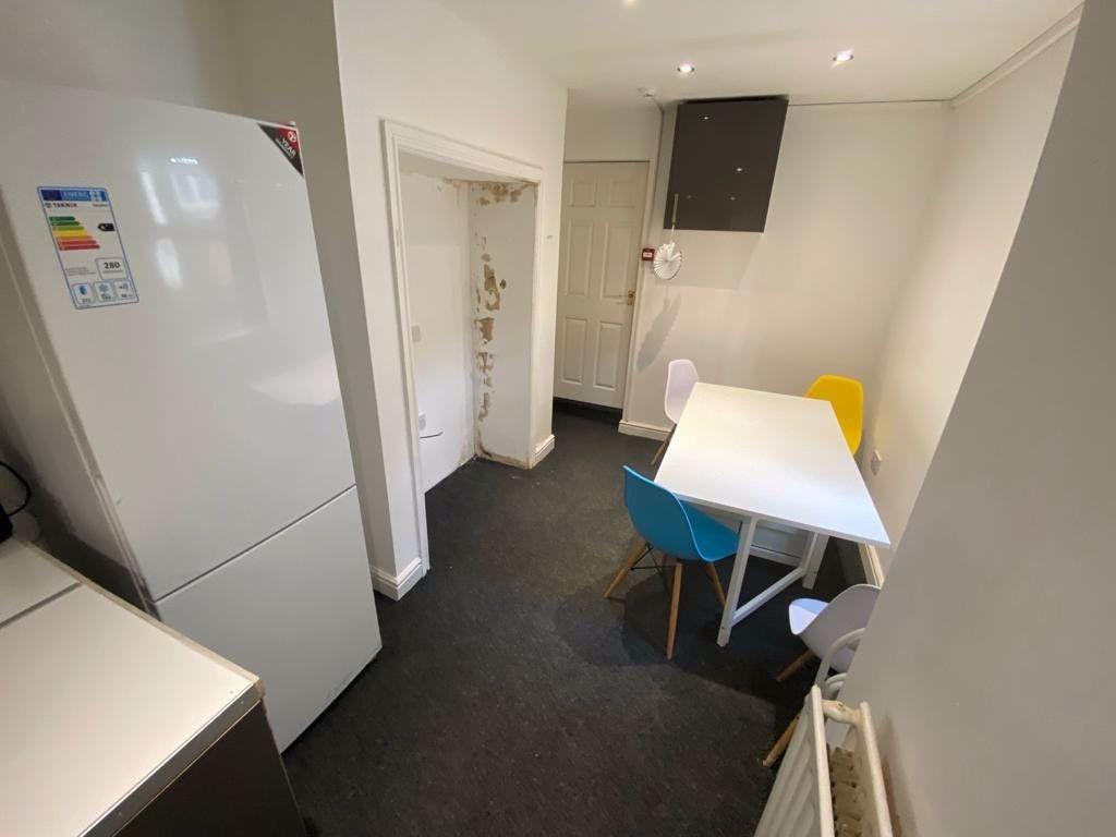 A bright and tidy kitchen area with modern appl...